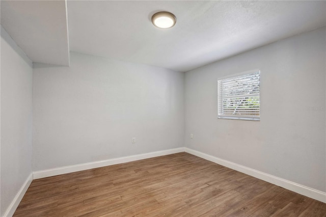 unfurnished room with light wood-type flooring and baseboards