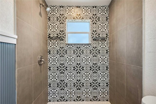 full bathroom with tiled shower