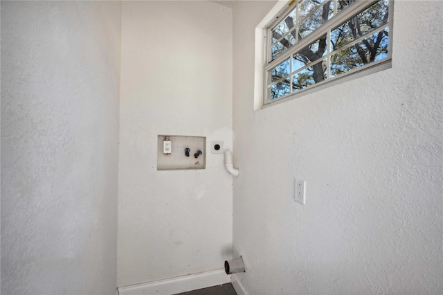 laundry area with laundry area, electric dryer hookup, and baseboards