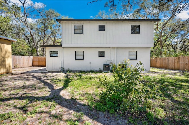 rear view of property with cooling unit and a fenced backyard