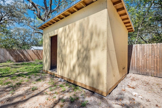 view of outbuilding with an outbuilding and fence