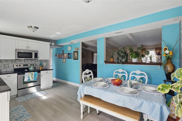 1211 E Camellia Dr, Brandon, FL 33510 - dining area with light wood-style floors and baseboards