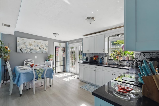 1211 E Camellia Dr, Brandon, FL 33510 - kitchen with freestanding refrigerator, dark countertops, tasteful backsplash, and a sink