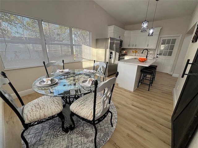 dining room with light wood-style flooring and baseboards