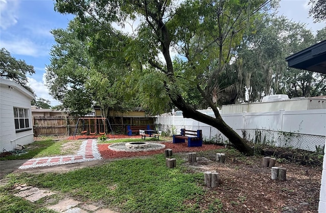 view of yard featuring a fenced backyard and an outdoor fire pit