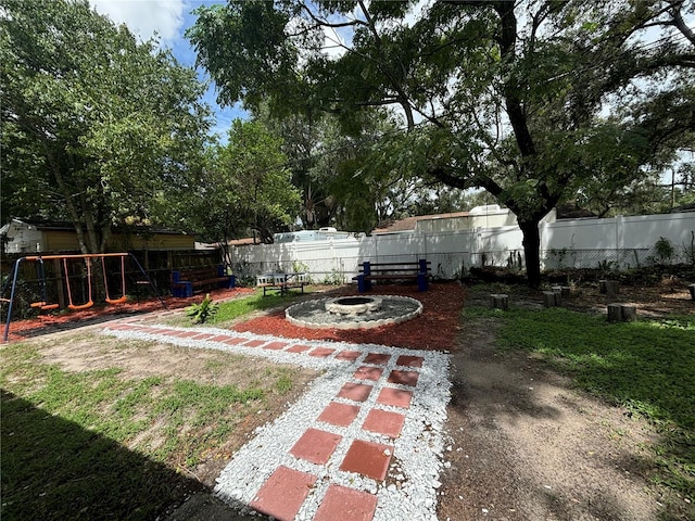 view of yard with a fire pit and fence private yard