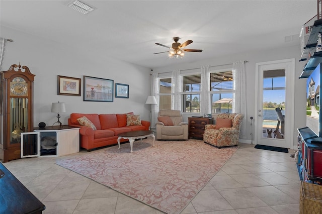 tiled living room featuring visible vents and a ceiling fan