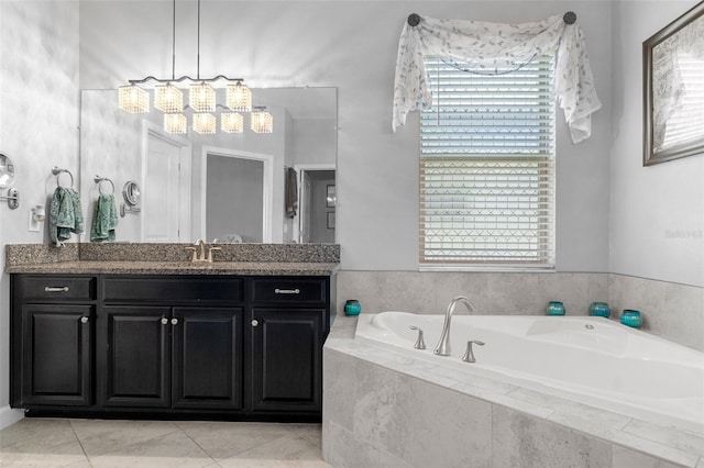 bathroom with tile patterned floors, vanity, and a garden tub