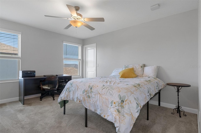 bedroom featuring carpet flooring, multiple windows, and baseboards