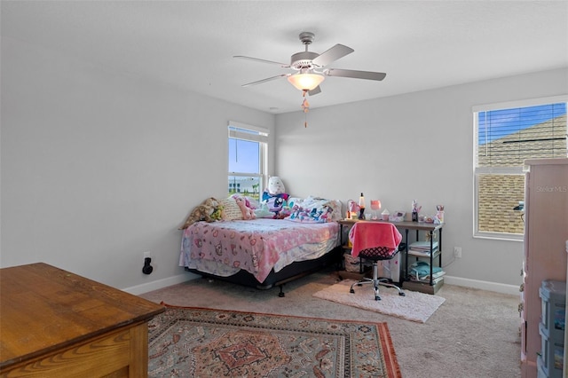 carpeted bedroom with baseboards and ceiling fan