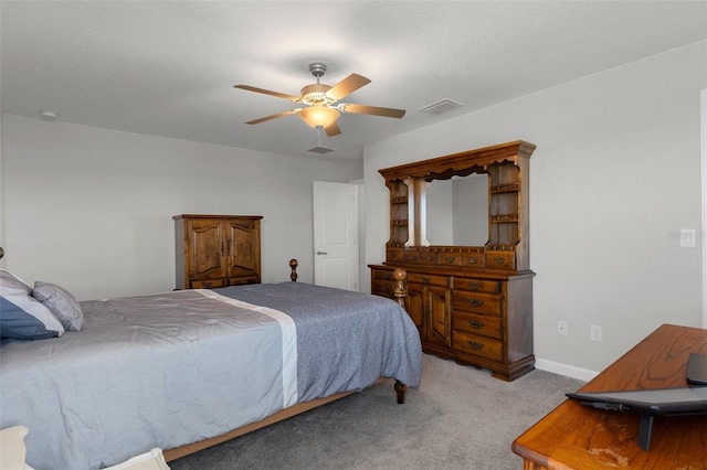 carpeted bedroom featuring visible vents, baseboards, and ceiling fan