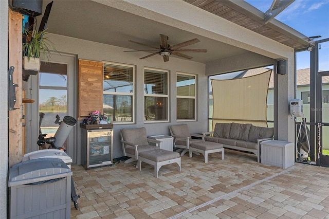 view of patio with a lanai, a ceiling fan, and an outdoor hangout area