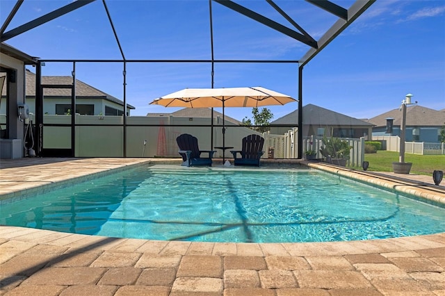 view of pool with glass enclosure, a fenced in pool, and fence