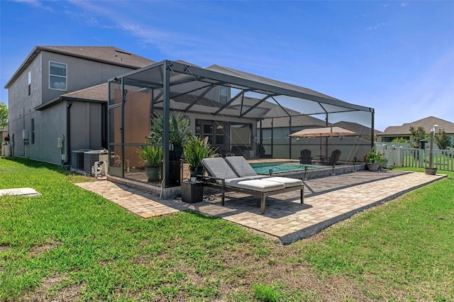 rear view of house featuring central air condition unit, a lawn, glass enclosure, a fenced backyard, and a patio area