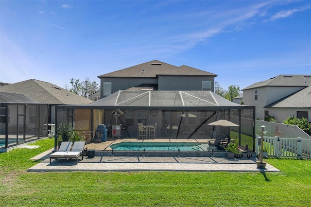 back of house featuring a fenced in pool, a lanai, a fenced backyard, a yard, and a patio