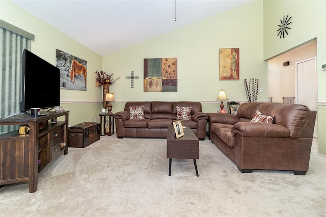 carpeted living area with lofted ceiling