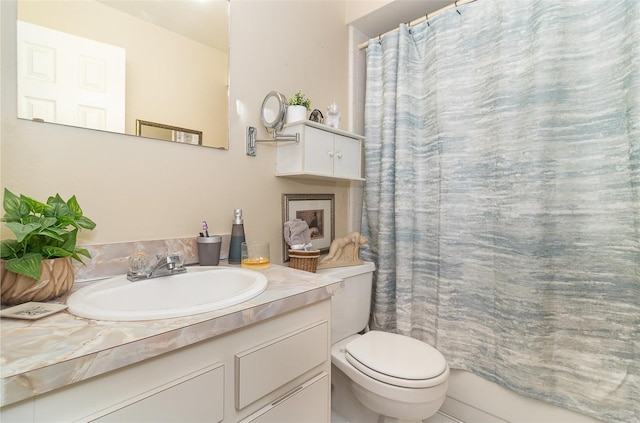 bathroom featuring curtained shower, toilet, and vanity