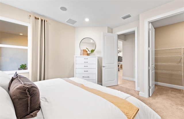 bedroom featuring light carpet, visible vents, recessed lighting, and baseboards