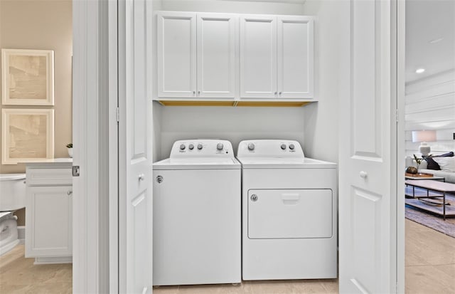 laundry room with cabinet space and separate washer and dryer