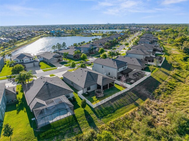 drone / aerial view featuring a residential view and a water view