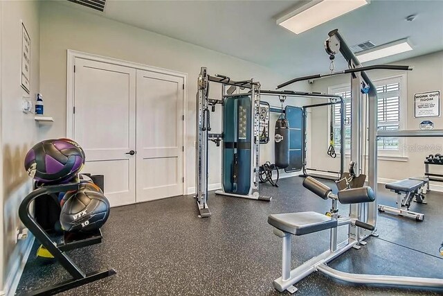 gym with baseboards and visible vents