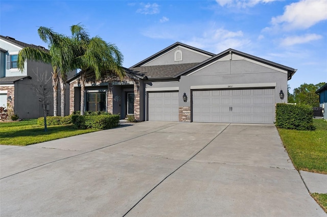 view of front of home featuring stucco siding, an attached garage, driveway, and a front lawn