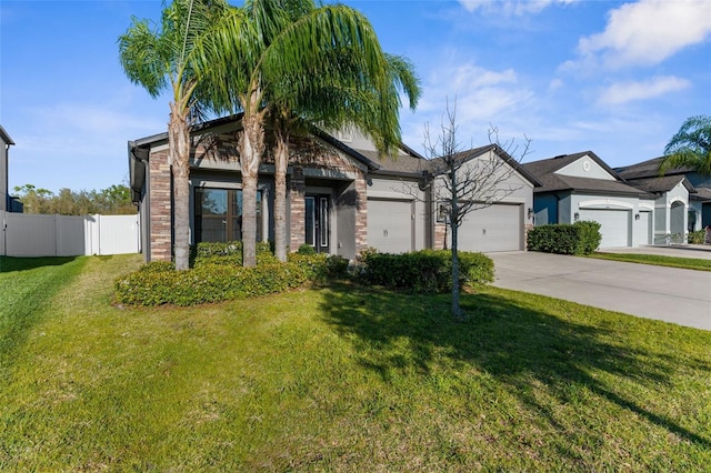 view of front of home featuring driveway, a front yard, an attached garage, and fence