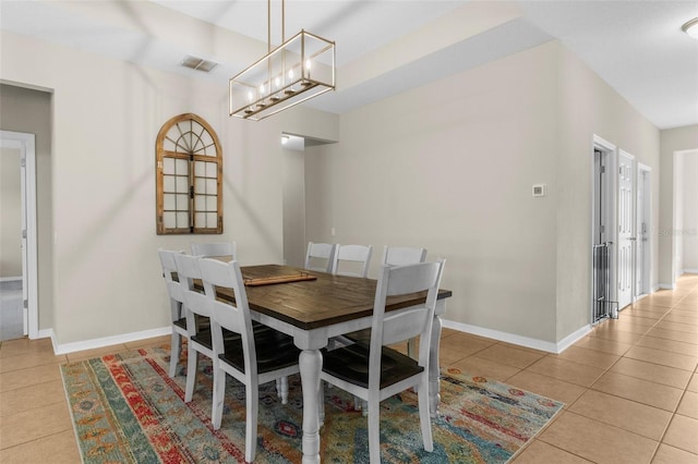 dining space with visible vents, baseboards, light tile patterned flooring, and a chandelier