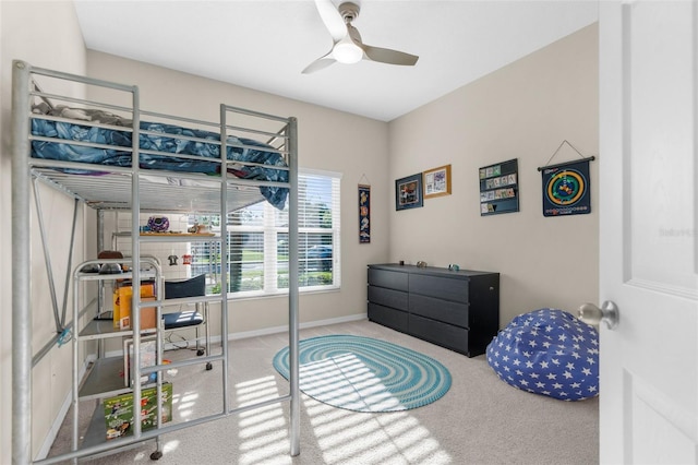 carpeted bedroom featuring a ceiling fan and baseboards