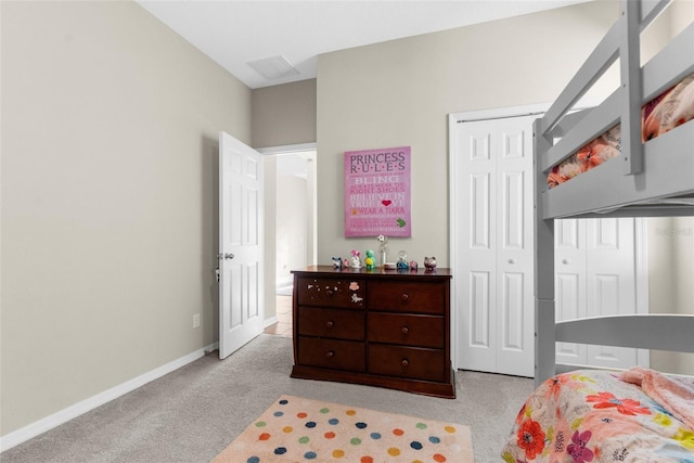 bedroom featuring baseboards, carpet floors, and a closet