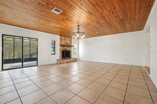 unfurnished living room featuring wood ceiling, light tile patterned floors, a fireplace, and visible vents