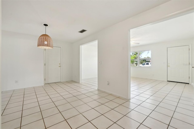 empty room with light tile patterned floors and visible vents