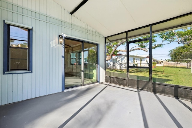 unfurnished sunroom with vaulted ceiling