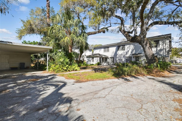 view of front of property featuring an attached carport and driveway