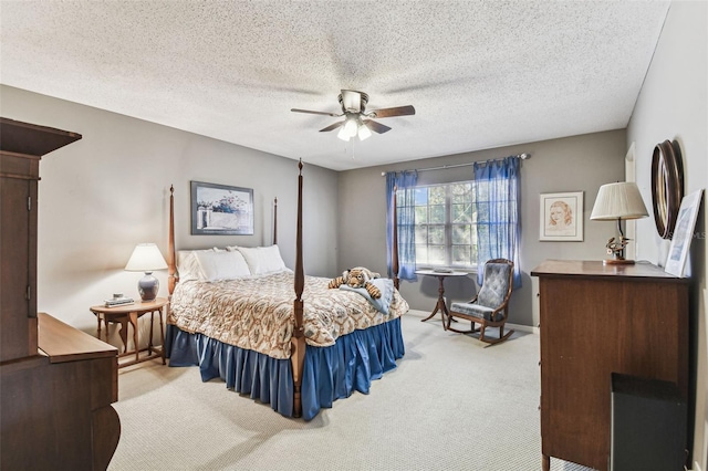 carpeted bedroom with a ceiling fan, baseboards, and a textured ceiling