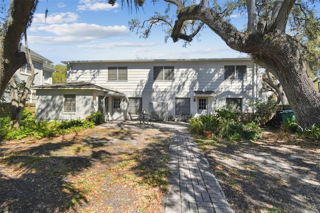 view of front of house featuring a patio and brick siding