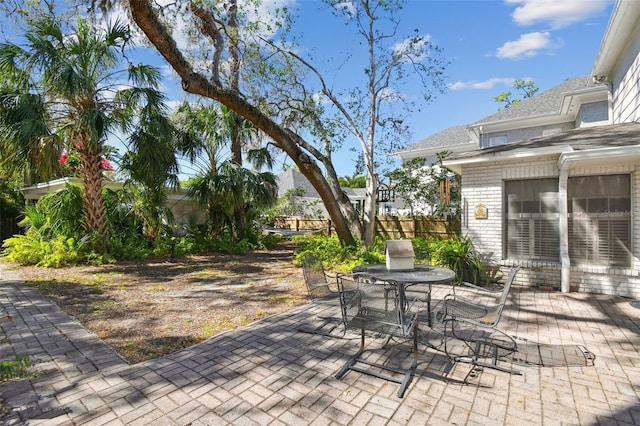 view of patio with outdoor dining area and fence