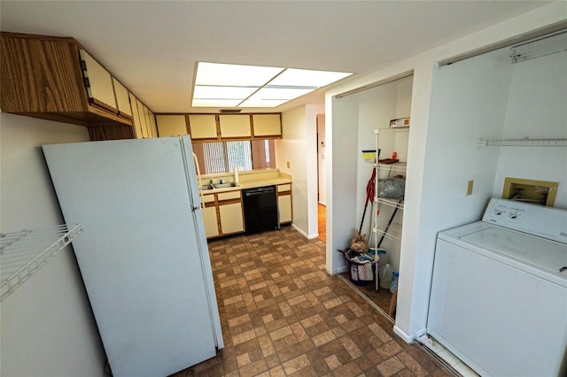 6125 113th St Unit 505, Seminole, FL 33772 - kitchen with washer / dryer, freestanding refrigerator, dishwasher, light countertops, and brick patterned flooring