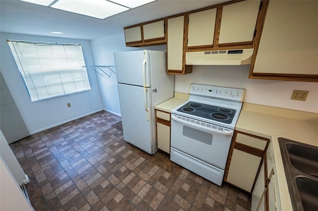 6125 113th St Unit 505, Seminole, FL 33772 - kitchen with under cabinet range hood, white appliances, light countertops, and brick patterned floors