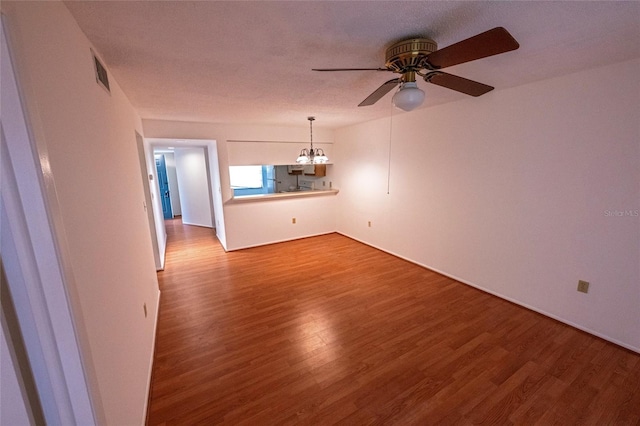 6125 113th St Unit 505, Seminole, FL 33772 - unfurnished room with wood finished floors, ceiling fan, and a chandelier