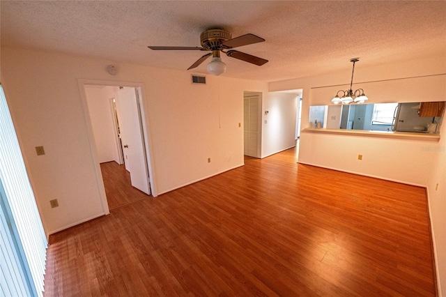 6125 113th St Unit 505, Seminole, FL 33772 - unfurnished room with a chandelier, wood finished floors, a textured ceiling, and ceiling fan