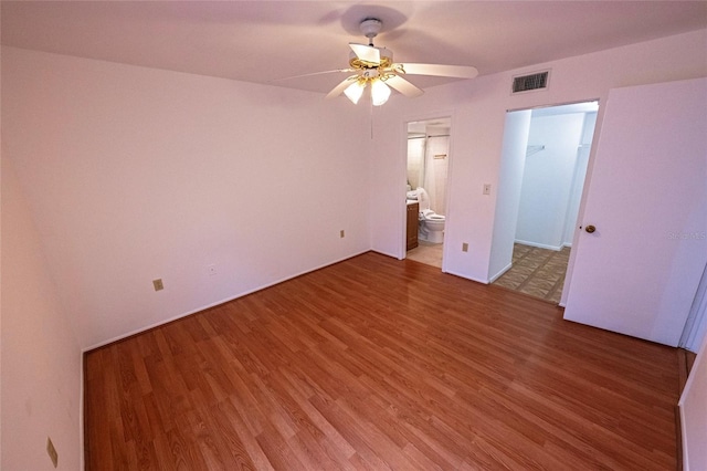 6125 113th St Unit 505, Seminole, FL 33772 - unfurnished bedroom with light wood-type flooring, a walk in closet, ensuite bathroom, and a ceiling fan