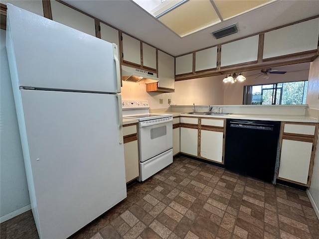 6125 113th St Unit 505, Seminole, FL 33772 - kitchen featuring white appliances, under cabinet range hood, light countertops, brick patterned floors, and white cabinets