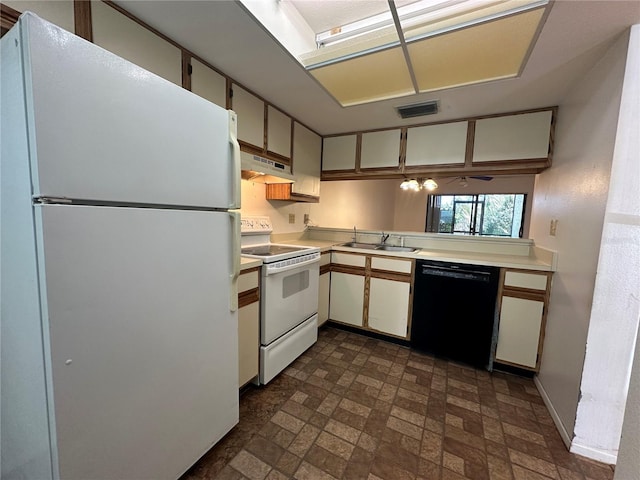 6125 113th St Unit 505, Seminole, FL 33772 - kitchen featuring white appliances, light countertops, under cabinet range hood, and brick patterned floors