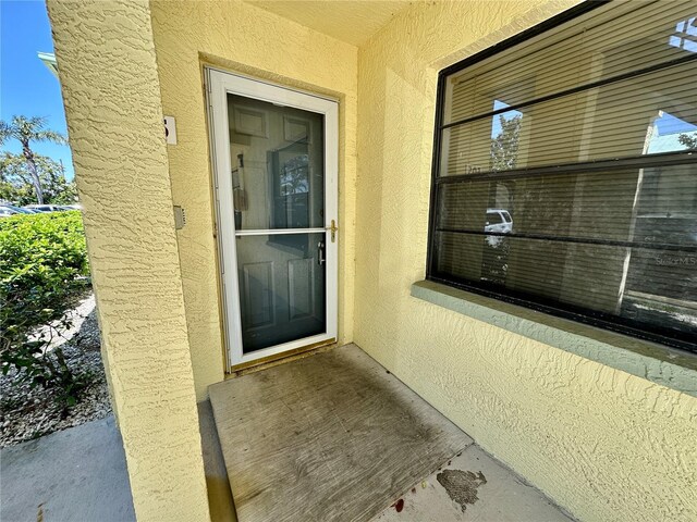 6125 113th St Unit 505, Seminole, FL 33772 - view of exterior entry featuring stucco siding
