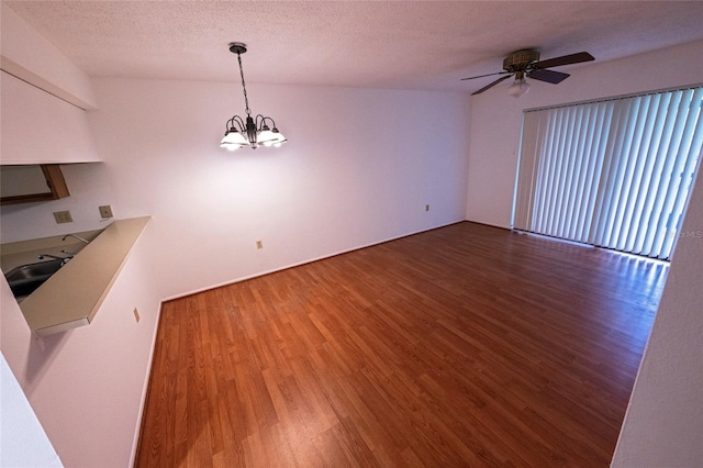 6125 113th St Unit 505, Seminole, FL 33772 - unfurnished dining area featuring wood finished floors, a chandelier, a ceiling fan, and a textured ceiling