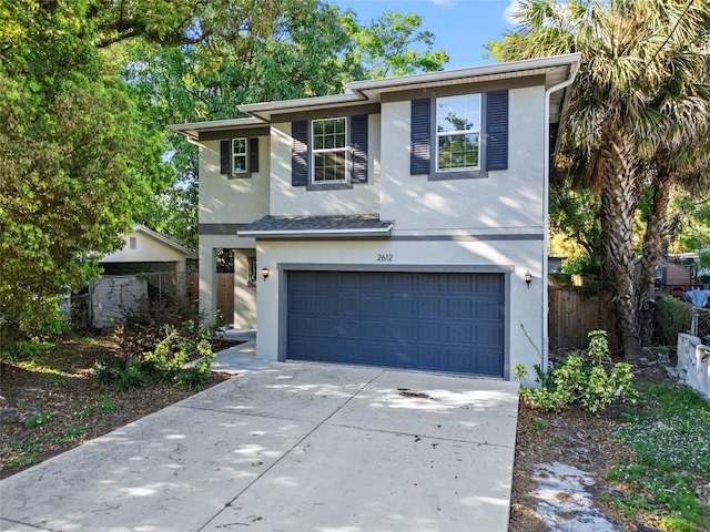 2612 E 26th Ave, Tampa, FL 33605 - traditional-style home with stucco siding, driveway, an attached garage, and fence