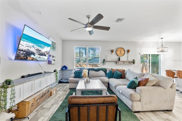 2612 E 26th Ave, Tampa, FL 33605 - living room with visible vents, ceiling fan with notable chandelier, and wood finish floors