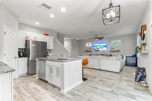 2612 E 26th Ave, Tampa, FL 33605 - kitchen featuring visible vents, a sink, stainless steel appliances, white cabinets, and open floor plan