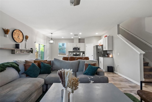 2612 E 26th Ave, Tampa, FL 33605 - living area featuring visible vents, recessed lighting, light wood finished floors, baseboards, and stairs